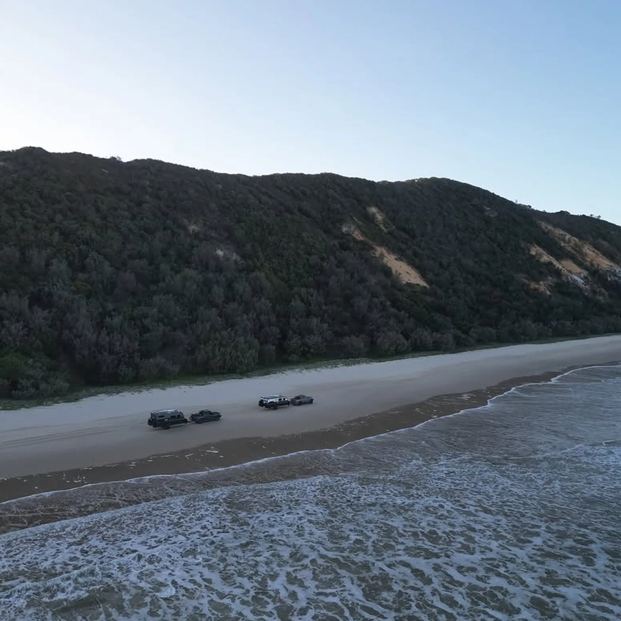 vehicles camping along remote beach