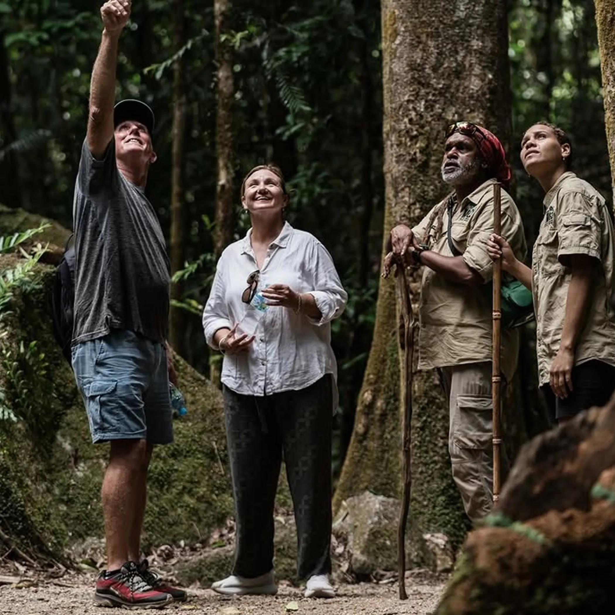 people exploring rainforest with indigenous guides