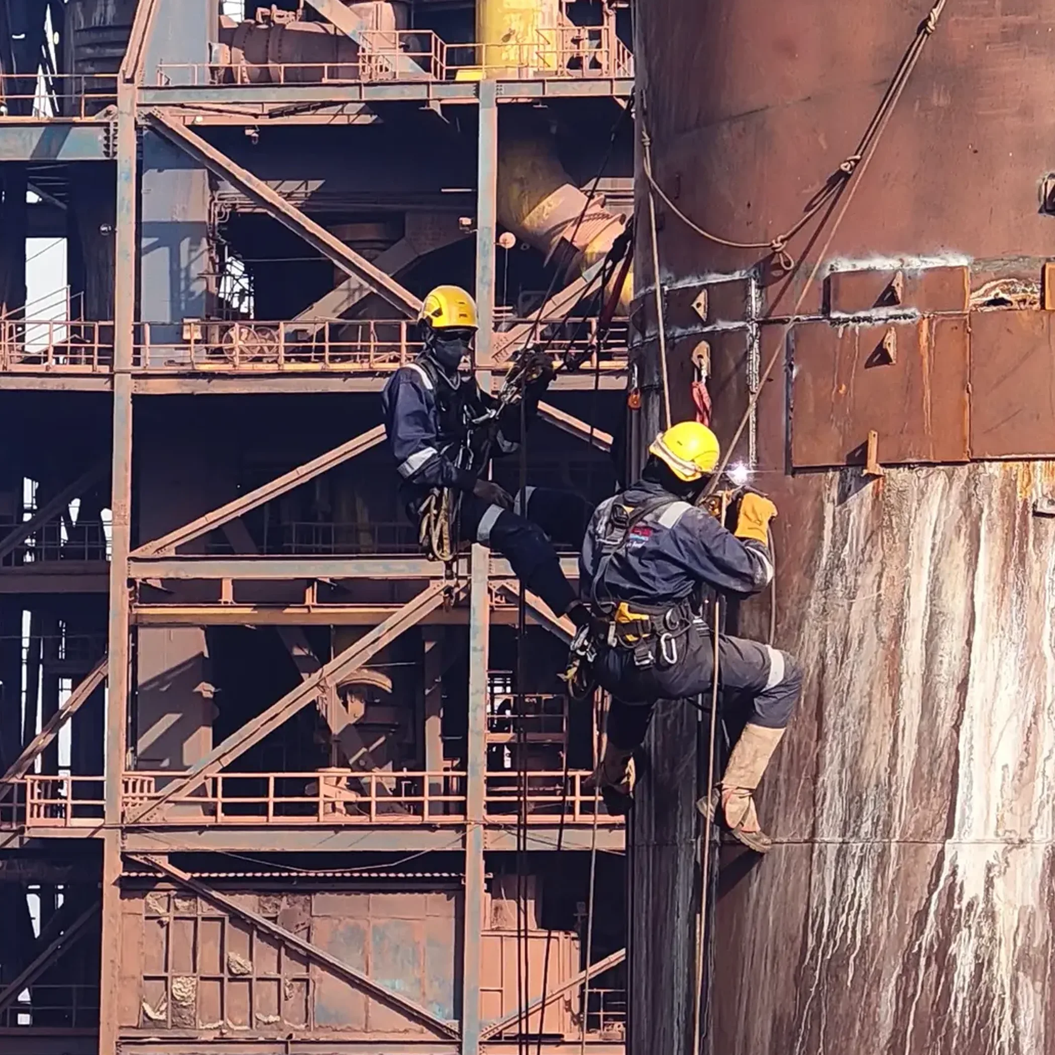 professionals using rope access equipment afloat